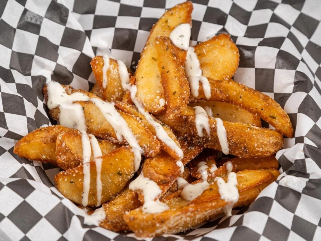 Garlic parmesan potato wedges with dipping sauce at Wing Crafters in London, ON